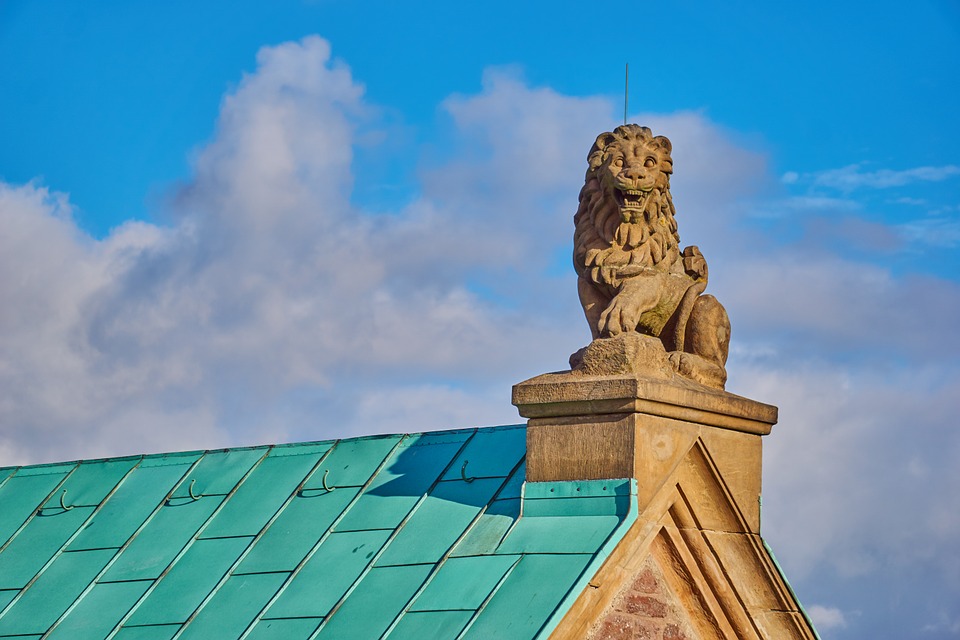 house roof with a lion sculpture